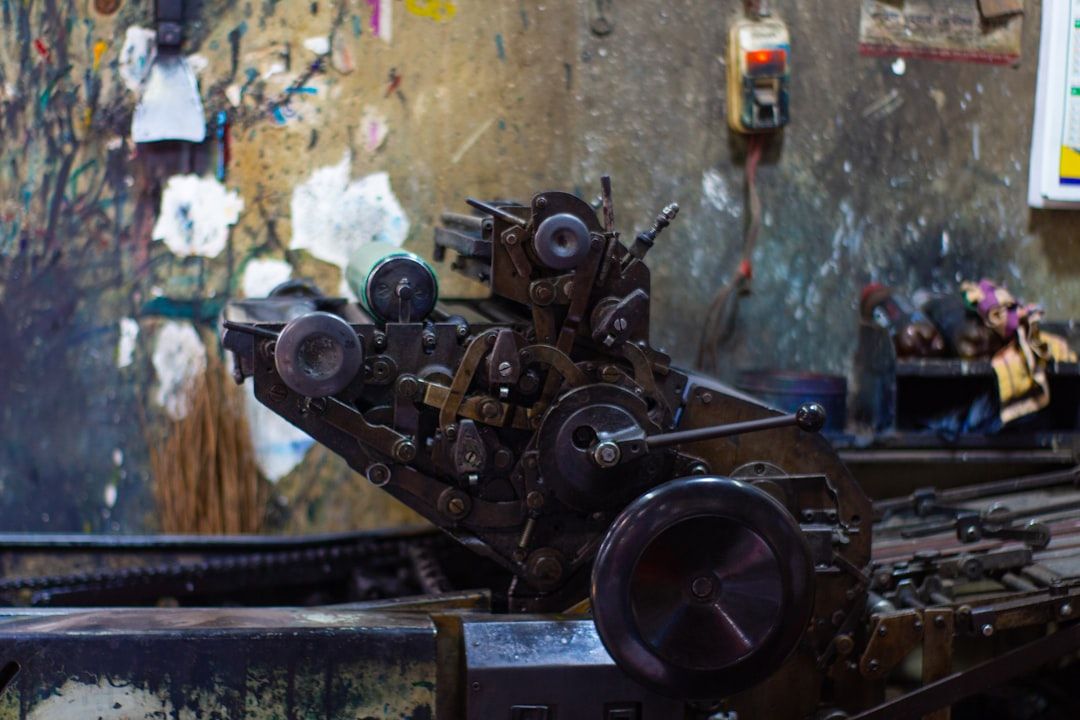 Close-up of a vintage mechanical offset printing press in a workshop.