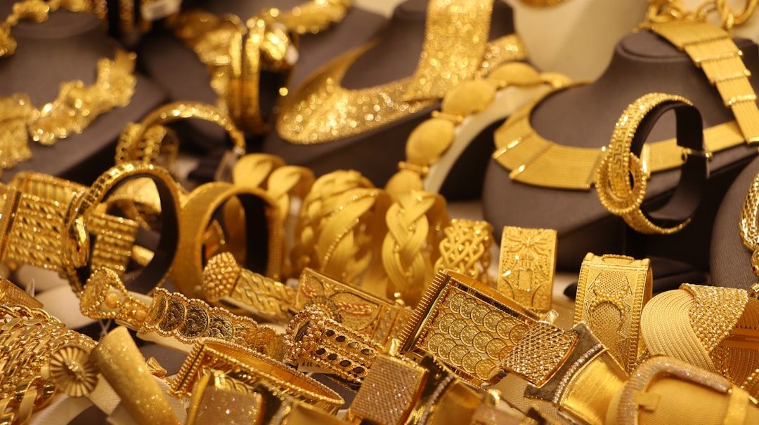 An array of ornate gold jewelry including necklaces and bracelets on display.