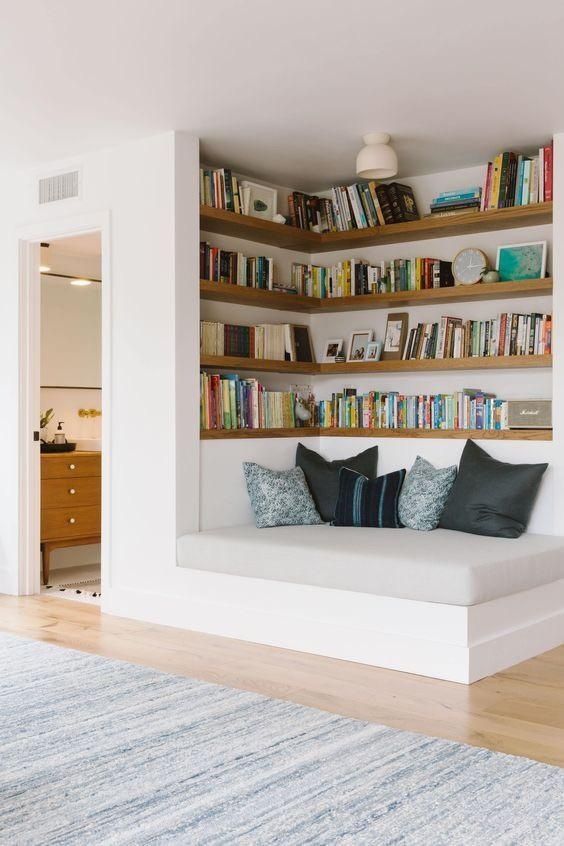 Built-in home library with neatly arranged books and a window seat